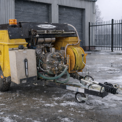 Jetter unit in a yard with snow and ice on the ground