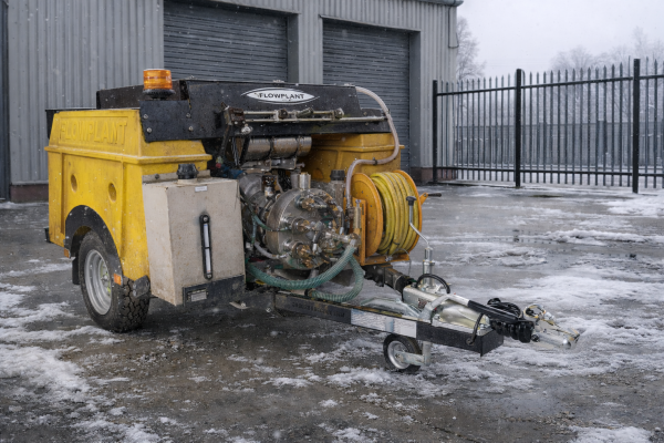Jetter unit in a yard with snow and ice on the ground